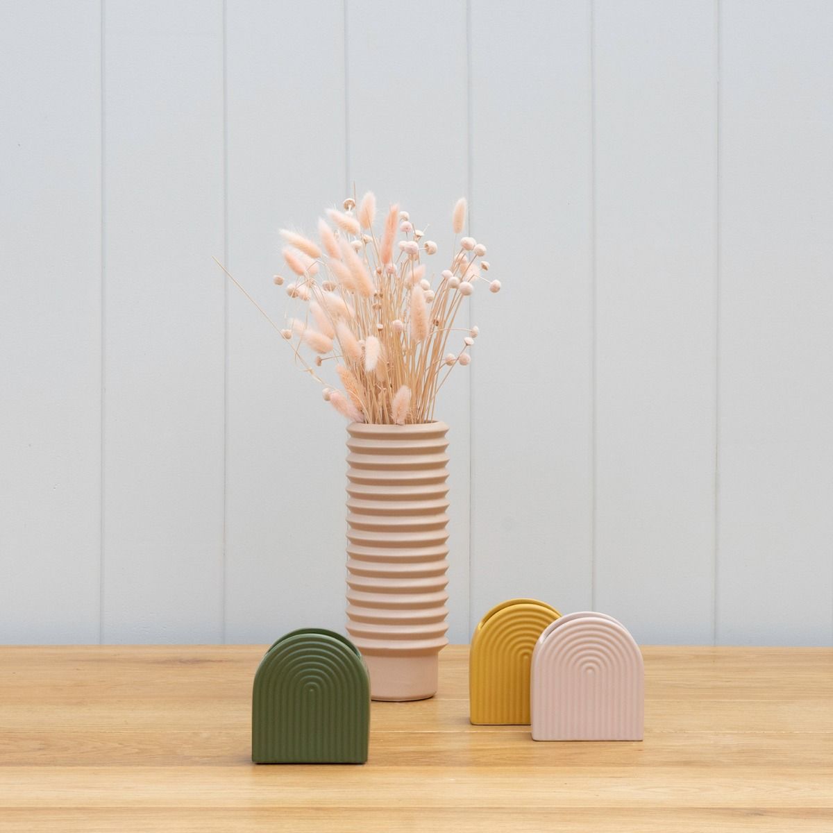 A Gatsby Vase - Peach by Potted with dried flowers in it on a wooden table.