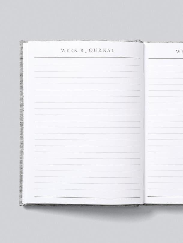 A Write To Me pregnancy journal with a white cover and a white line on it.