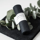 A black SWEDISH DISH CLOTH with eucalyptus leaves on it that is biodegradable and recyclable by Barkly Basics.
