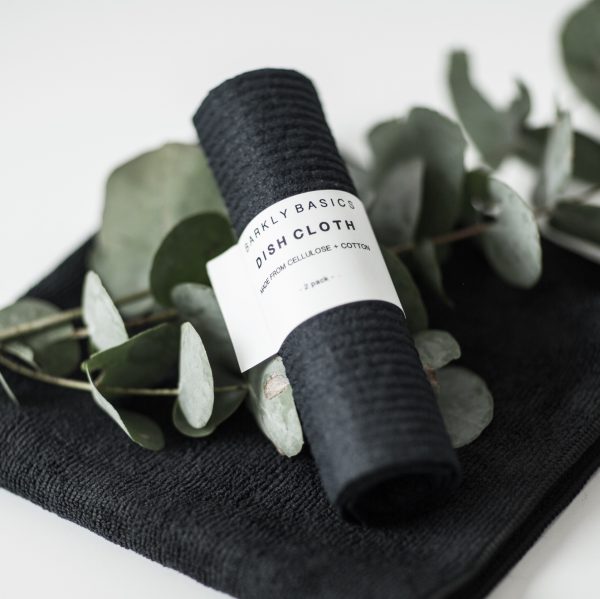 A Barkly Basics Microfibre Cloth - Pack of 2 with eucalyptus leaves on it.