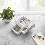 An Umbra STOWIT MINI JEWELRY BOX WHT/NKL with hidden compartments on a marble countertop.
