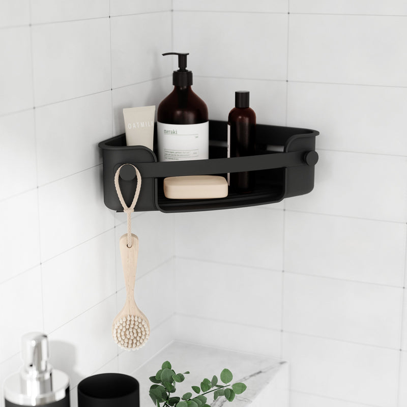A bathroom corner shelf with Umbra's Flex Gel-Lock Corner Bin for maximizing corner space in the room.