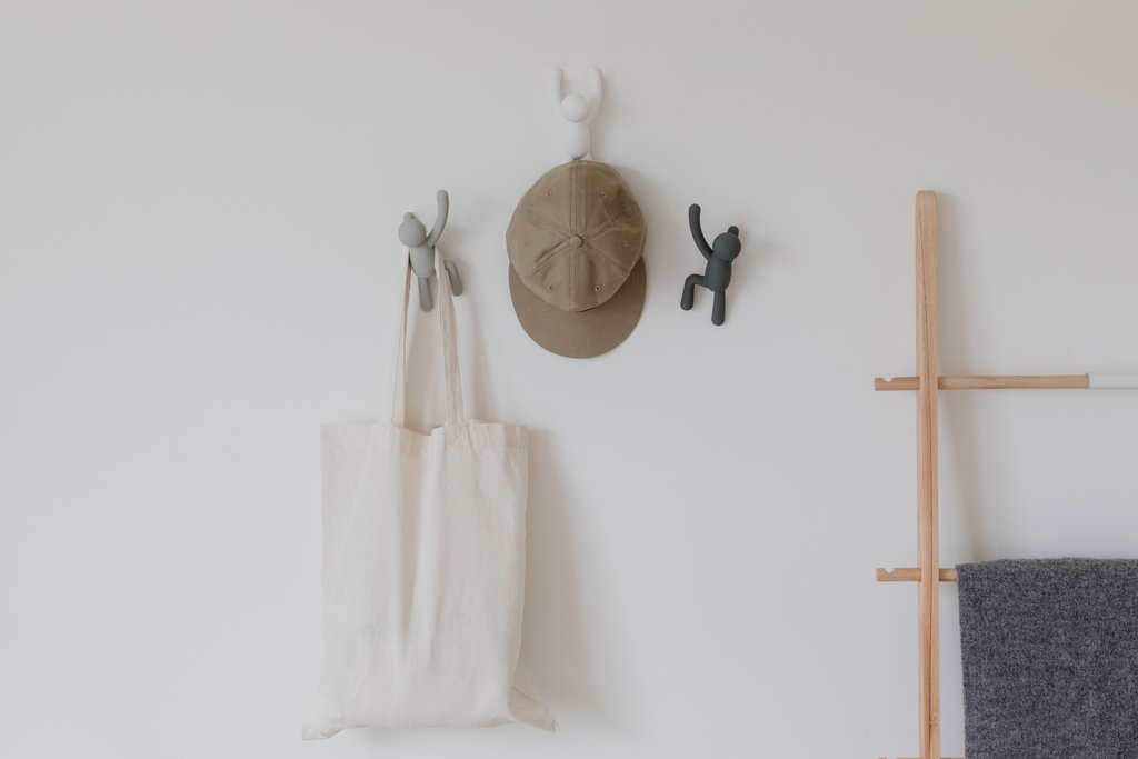 Umbra Buddy Hooks in multi grey on a white wall with a bag hanging