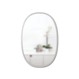 An Umbra HUB MIRROR OVAL 61 X 91 GREY with a rubber rim on a white wall.
