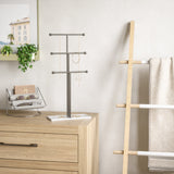 A bathroom with an Umbra TRIGEM JEWELRY STAND NICKEL for accessory storage.