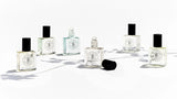 Five The Perfume Oil Collection Gift Set - Floral bottles from The Perfume Oil Company sitting on a white surface.