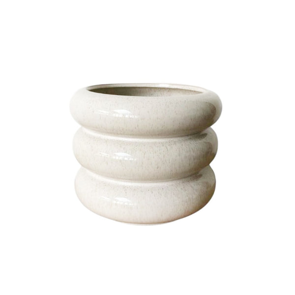 A tall white Milan Planter Sandstorm on a white background, brand Potted.