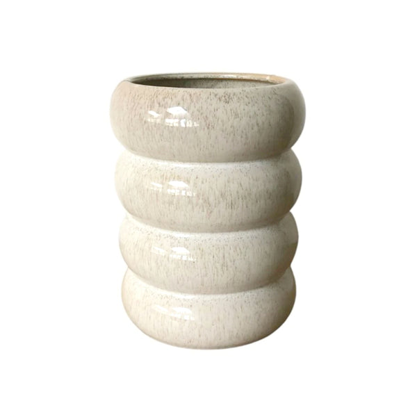 A Milan Planter Sandstorm by Potted, a tall white vase with three stacked tiers on a white background.