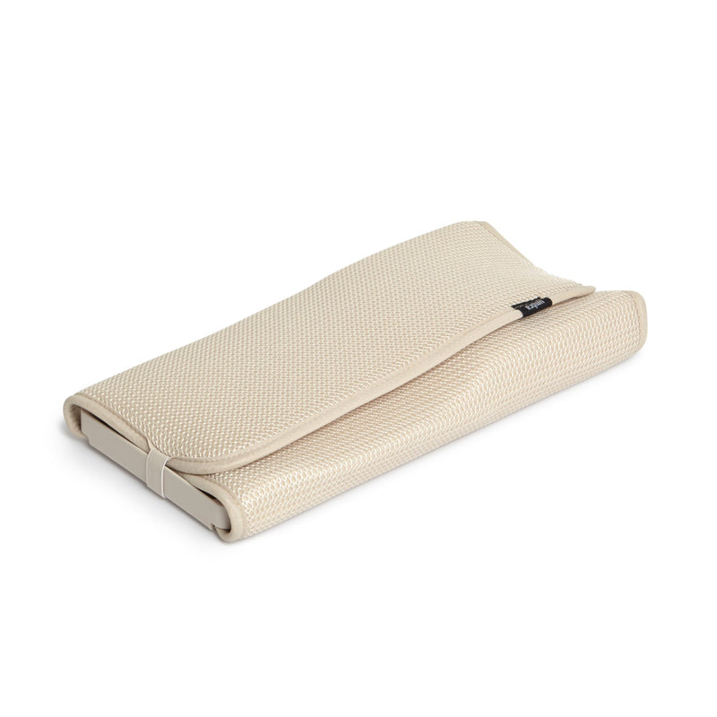 A white Udry Drying Mat Mini with a beige pillow case by Umbra.