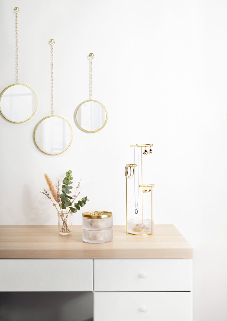 A white dresser with gold mirrors and an Umbra Tesora Jewellery Stand - Glass / Brass.
