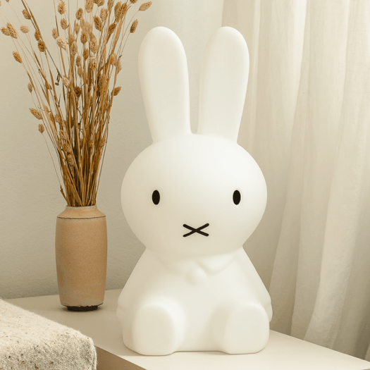 Mr Maria Miffy Star Light beside a vase of dried grasses by a sheer curtain