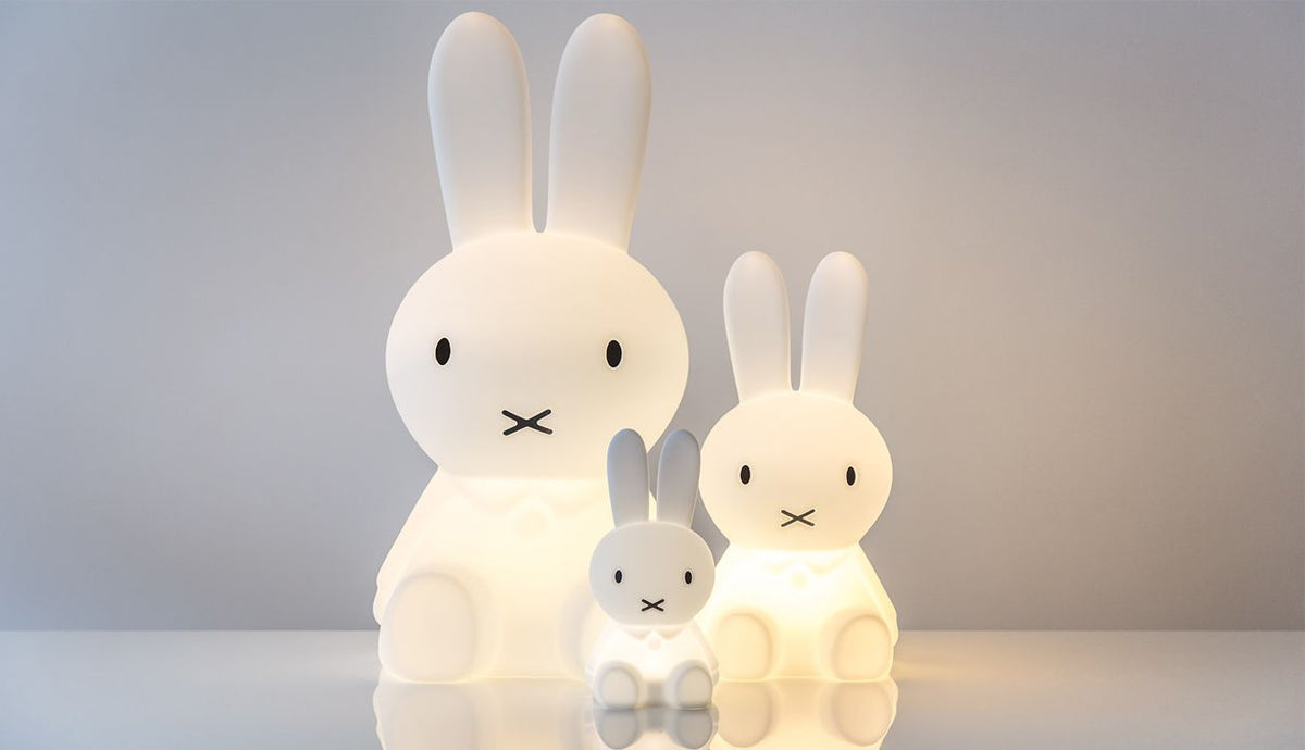 Three Mr Maria Miffy bunny lamps glowing side by side in large, medium and small sizes