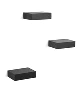 Three Umbra black floating shelves on a white background.