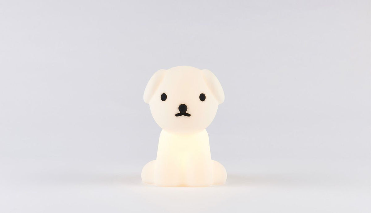 Snuffy dog lamp glowing on grey