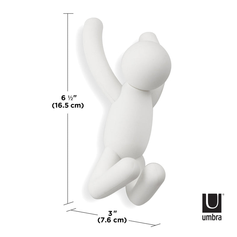 An Umbra Buddy Hooks White - Set of 3 serving as a quirky space-saving alternative on a wall.