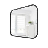 A decorative black mirror, the Umbra Hub Mirror - Rectangle 61X91" Black, hanging on a wall in a room.