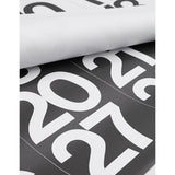 Rolled Stendig wall calendar showing the oversized white numerals on black