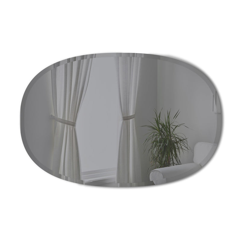 A room with an Umbra Hub Mirror - Bevy Oval 24X36 - Smoke, curtains, and a plant.