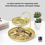 An ideal solution for organizing small items like glasses and change, the Poise Two Tier Ring Dish Brass from the Umbra range of products doubles as a jewelry holder.