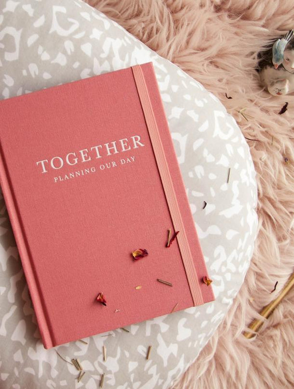 A pink wedding planner with the brand name "Write To Me" and the product name "Together - Planning Our Day" on it.