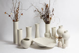 A group of unique Ned Collections Ronnie Vases handcrafted by skilled craftsmen and displayed on a clean white surface.