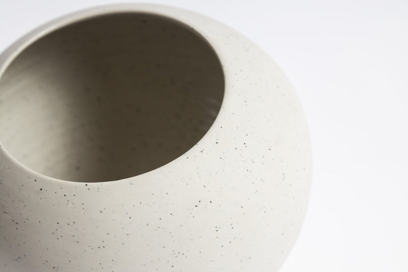 A unique pottery wheel creation featuring a RONNIE VASE from Ned Collections with speckles.