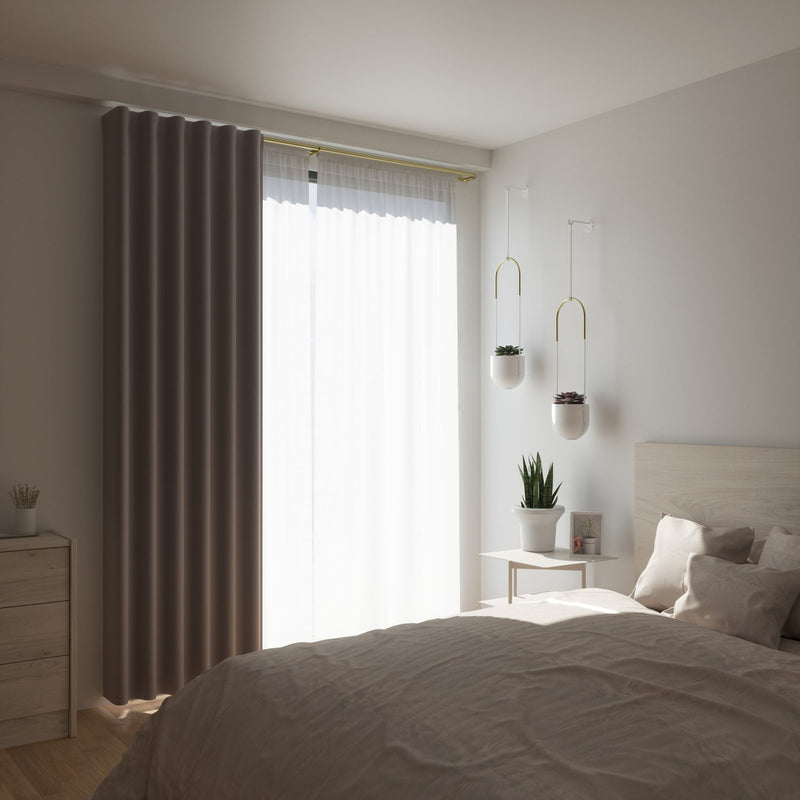 A bedroom with a white bed, white curtains, and an Umbra Bolo Planter - Black hanging planter.