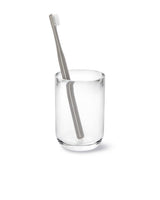 A Junip Tumbler - Acrylic by Umbra toothbrush in a glass cup on a white background.
