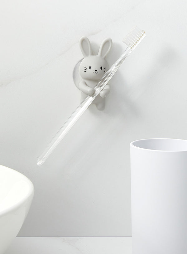 A RABBIT TOOTHBRUSH HOLDER with a strong suction cup, branded by Kikkerland.