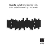A black and white poster displaying Umbra's Sticks Multi Hook - Black with condensed mounting hardware, easy to install wall coat racks.