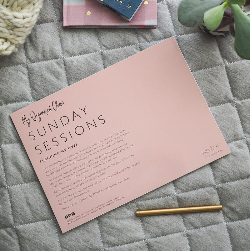 A pink notebook with the words Sunday Sessions - Planning My Week on it, designed by Write To Me to enhance organization and productivity during planning.