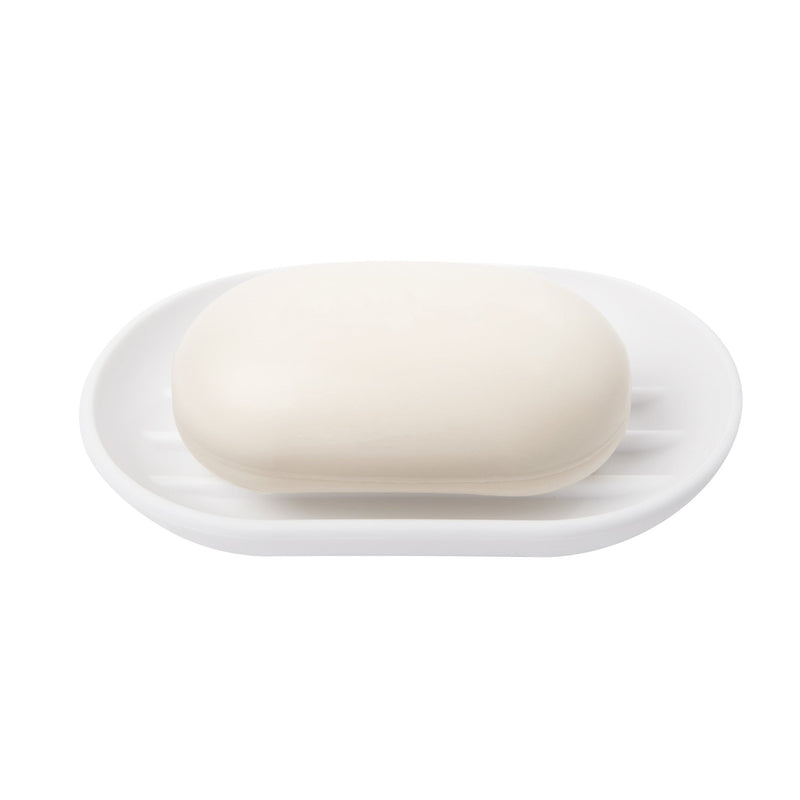 A white Umbra Touch Soap Dish on top of a soft-touch finish surface.