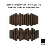 A pair of Picket Rail Wall Hooks from the Umbra range with modern wall art design that features flip hooks for instant storage.