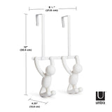 A pair of white BUDDY OVER THE DOOR HOOK WHITE from the Umbra range with two people hanging on them.