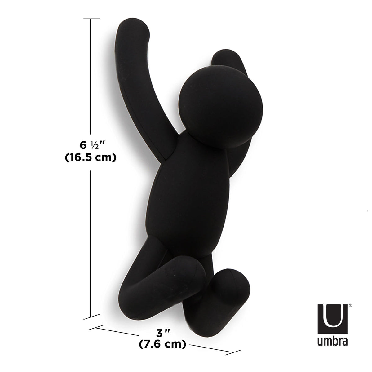 A Buddy Hooks Black - Set of 3 hanging on a wall, serving as both wall décor and a coat rack.