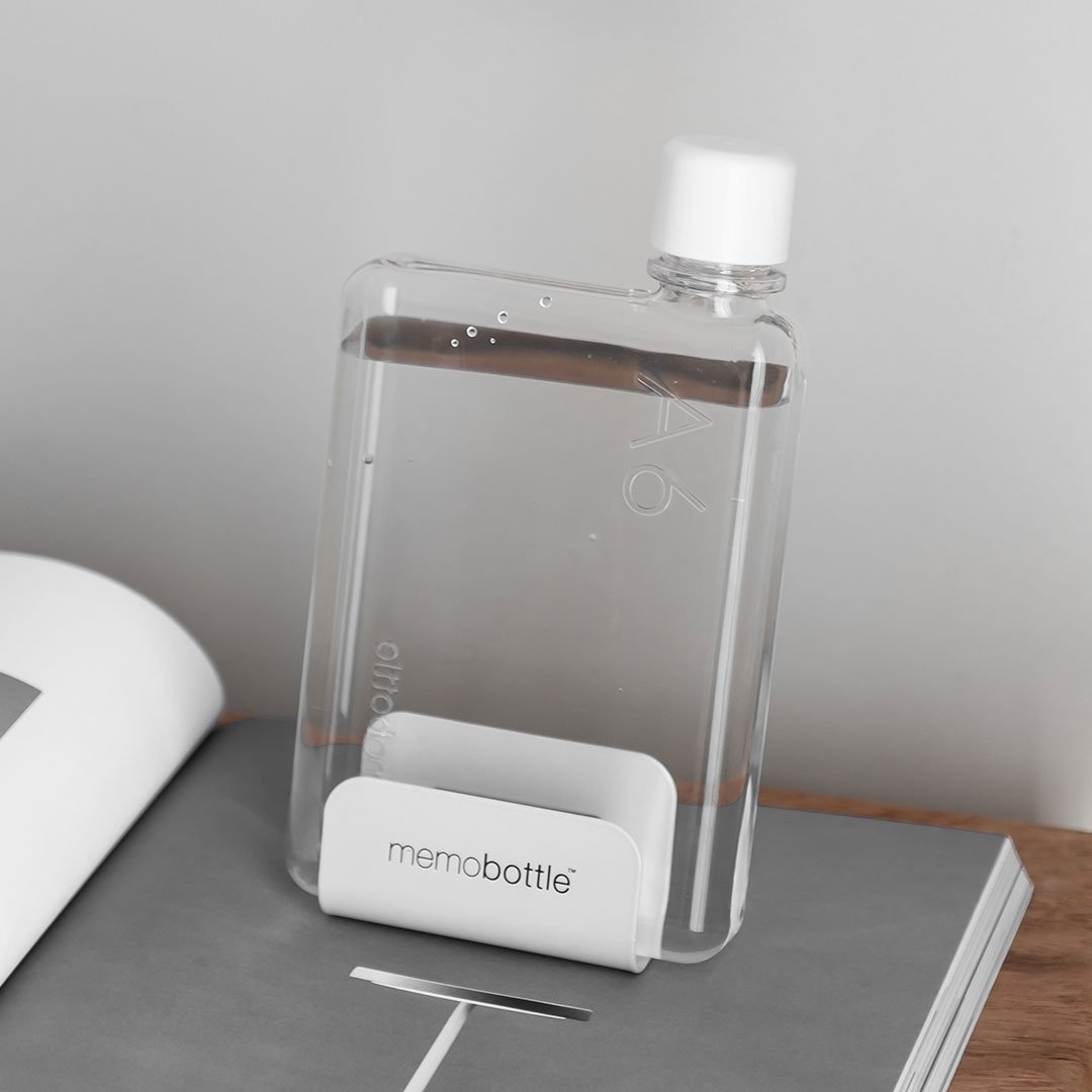 A5 Memobottle standing upright in a white desk stand on a desk