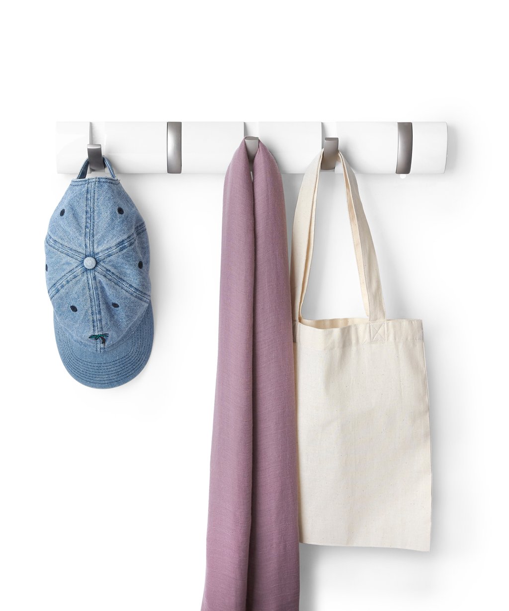 Umbra Flip 5 hook rack in white holding a denim cap, scarf and canvas tote