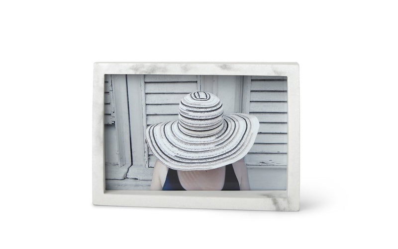 A woman wearing a striped hat in an Umbra Edge Marble Frame.