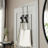 A Umbra BUDDY OVER THE DOOR HOOK BLACK with a white bag hanging on it.