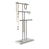 An Umbra Trigem Jewelry Stand Nickel with three necklaces hanging on a silver necklace holder.